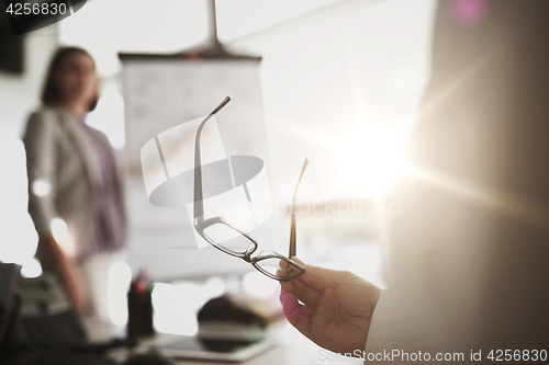 Image of businessman with glasses at presentation in office