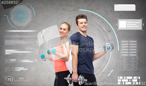 Image of sportive man and woman with dumbbells