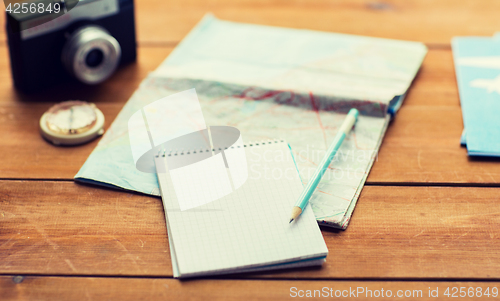 Image of close up of notepad with map and travel tickets