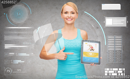 Image of sporty woman with fitness application on tablet pc