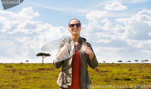 Image of happy woman with backpack traveling in africa