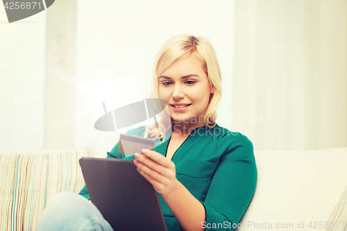 Image of happy woman with tablet pc and credit card