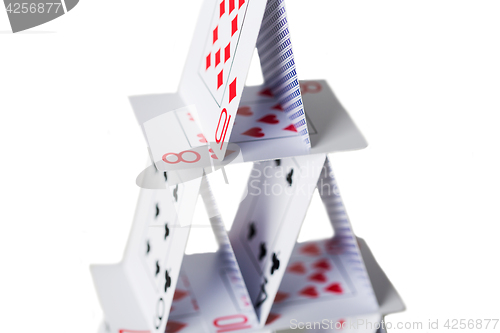 Image of house of playing cards over white background