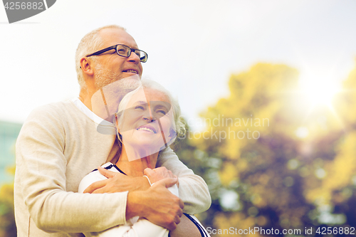 Image of senior couple hugging in park