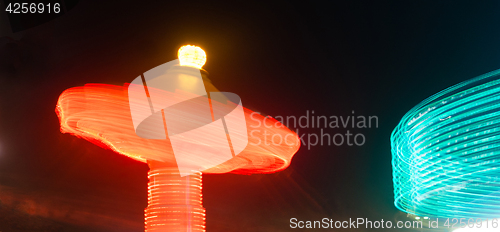 Image of Local State Fair Carnival Ride Long Exposure Red Blue Streaks