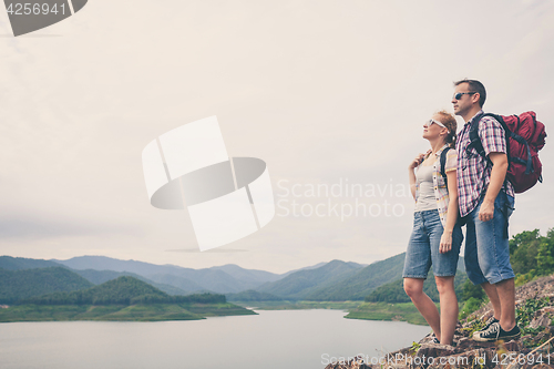 Image of Happy family standing near the lake.