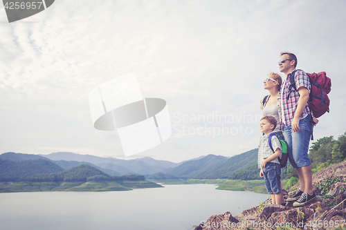 Image of Happy family standing near the lake.