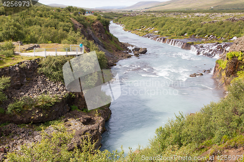 Image of Hraunfossar Iceland, woman watching