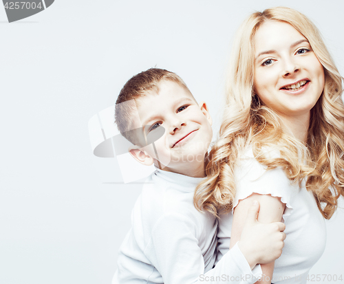 Image of young modern blond curly mother with cute son together happy smiling family posing cheerful on white background, lifestyle people concept, sister and brother friends 