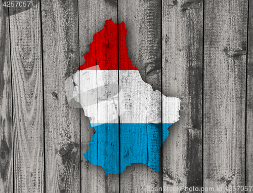 Image of Map and flag of Luxembourg on weathered wood