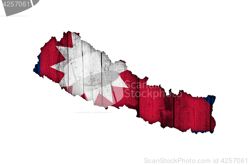 Image of Map and flag of Nepal on weathered wood