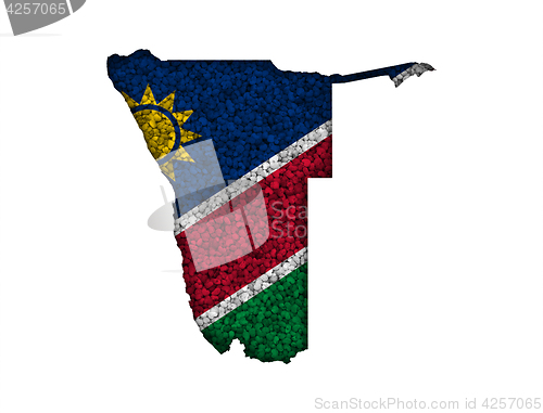 Image of Map and flag of Namibia on poppy seeds