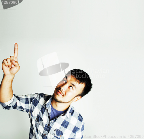 Image of young cute asian man on white background gesturing emotional, po