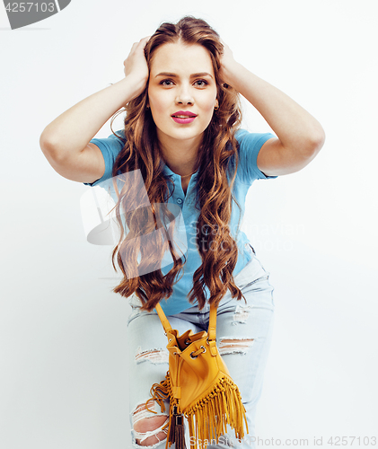 Image of young pretty long hair woman happy smiling isolated on white background, wearing cute tiny fashion handbag, lifestyle people concept