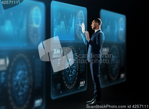 Image of businessman with virtual screens projection