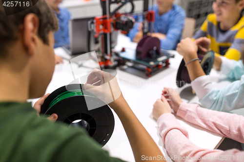 Image of children with 3d printer at robotics school