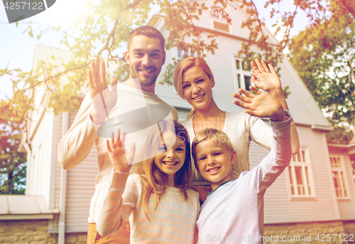 Image of happy family in front of house outdoors