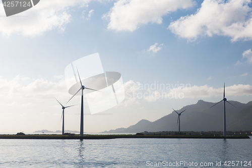 Image of turbines at wind farm on sea shore