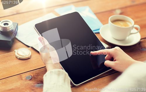 Image of close up of traveler hands with tablet pc and map