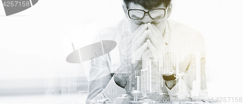 Image of tired businessman with eyeglasses at office