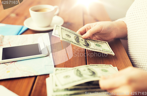 Image of close up of traveler hands counting dollar money