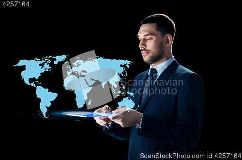 Image of businessman with tablet pc and world map