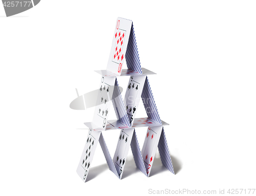 Image of house of playing cards over white background