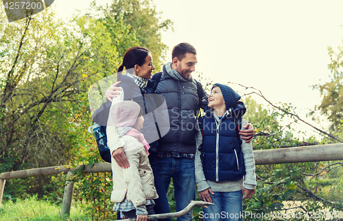 Image of happy family with backpacks hiking