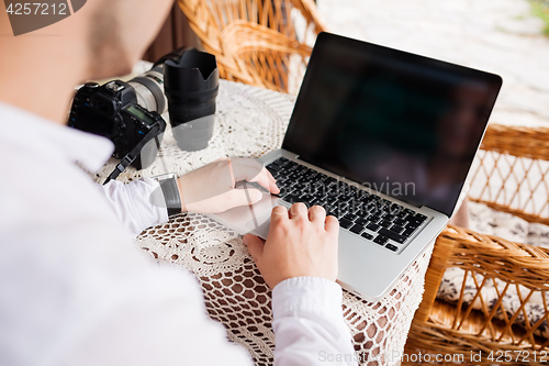 Image of Man is looking at laptop with excitement.