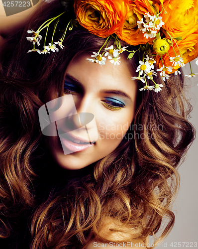 Image of Beauty young woman with flowers and make up close up, real sprin