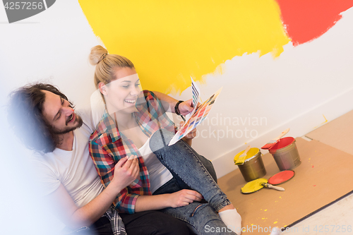 Image of Happy young couple relaxing after painting