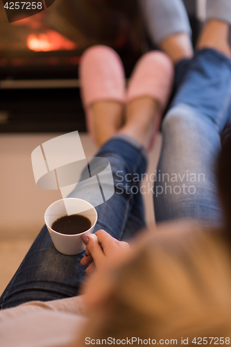 Image of Young couple  in front of fireplace