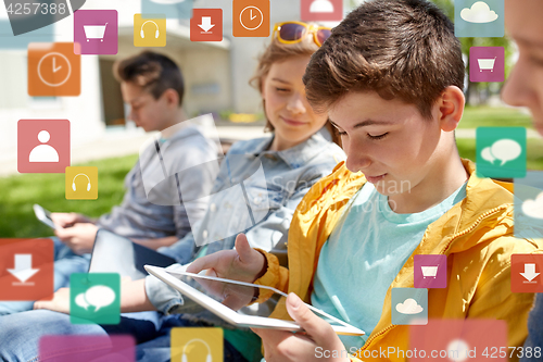 Image of happy friends or students with tablet pc outdoors