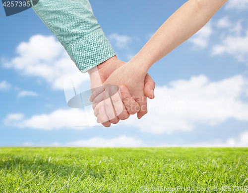 Image of happy father and child holding hands