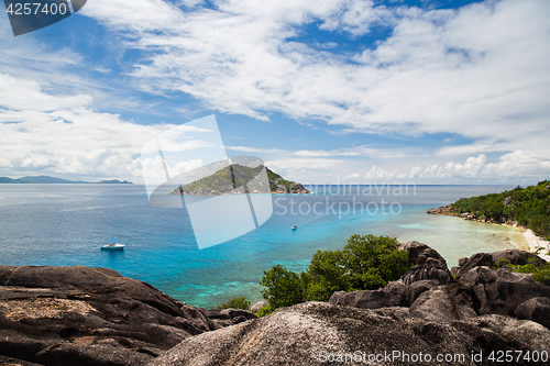 Image of island and boats in indian ocean on seychelles