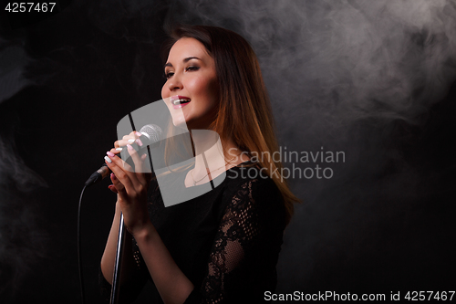 Image of Singing woman background of smoke