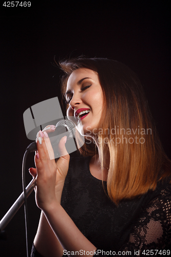 Image of Woman with microphone in studio