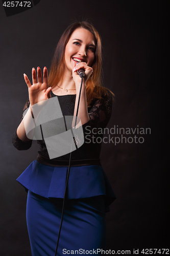 Image of Long haired singer with microphone