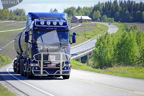 Image of Dark Blue Scania R580 Trucking Uphill at Summer