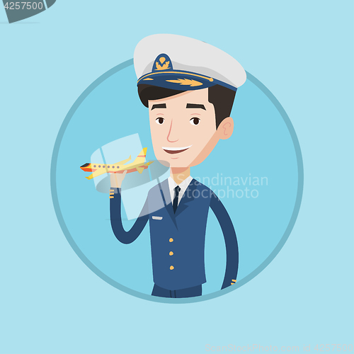 Image of Cheerful airline pilot with model airplane.