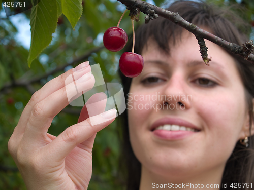 Image of Lady picks cherry