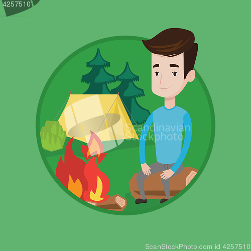 Image of Man sitting on log near campfire in the camping.