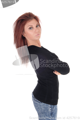 Image of Brunette woman standing in profile.