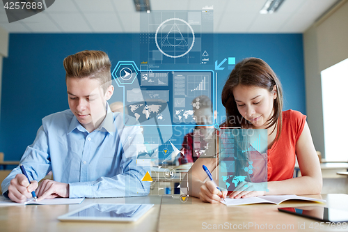 Image of group of students with books writing school test