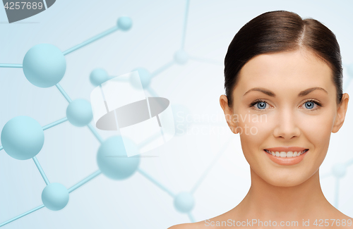 Image of beautiful young woman face with molecules