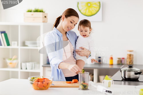 Image of happy mother and baby cooking food at home kitchen