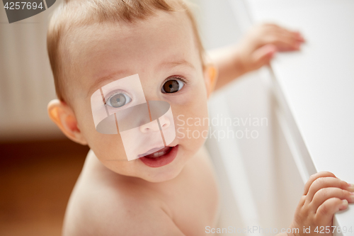Image of happy little baby boy or girl at home