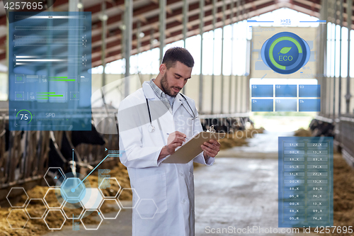 Image of veterinarian with cows in cowshed on dairy farm