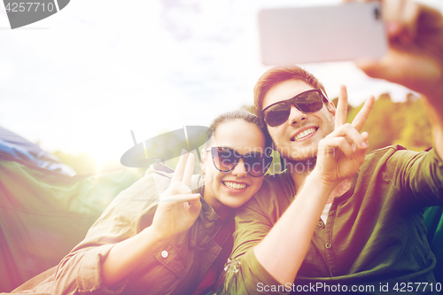 Image of couple of travelers taking selfie by smartphone