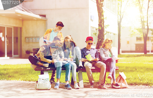 Image of group of students with notebooks at school yard